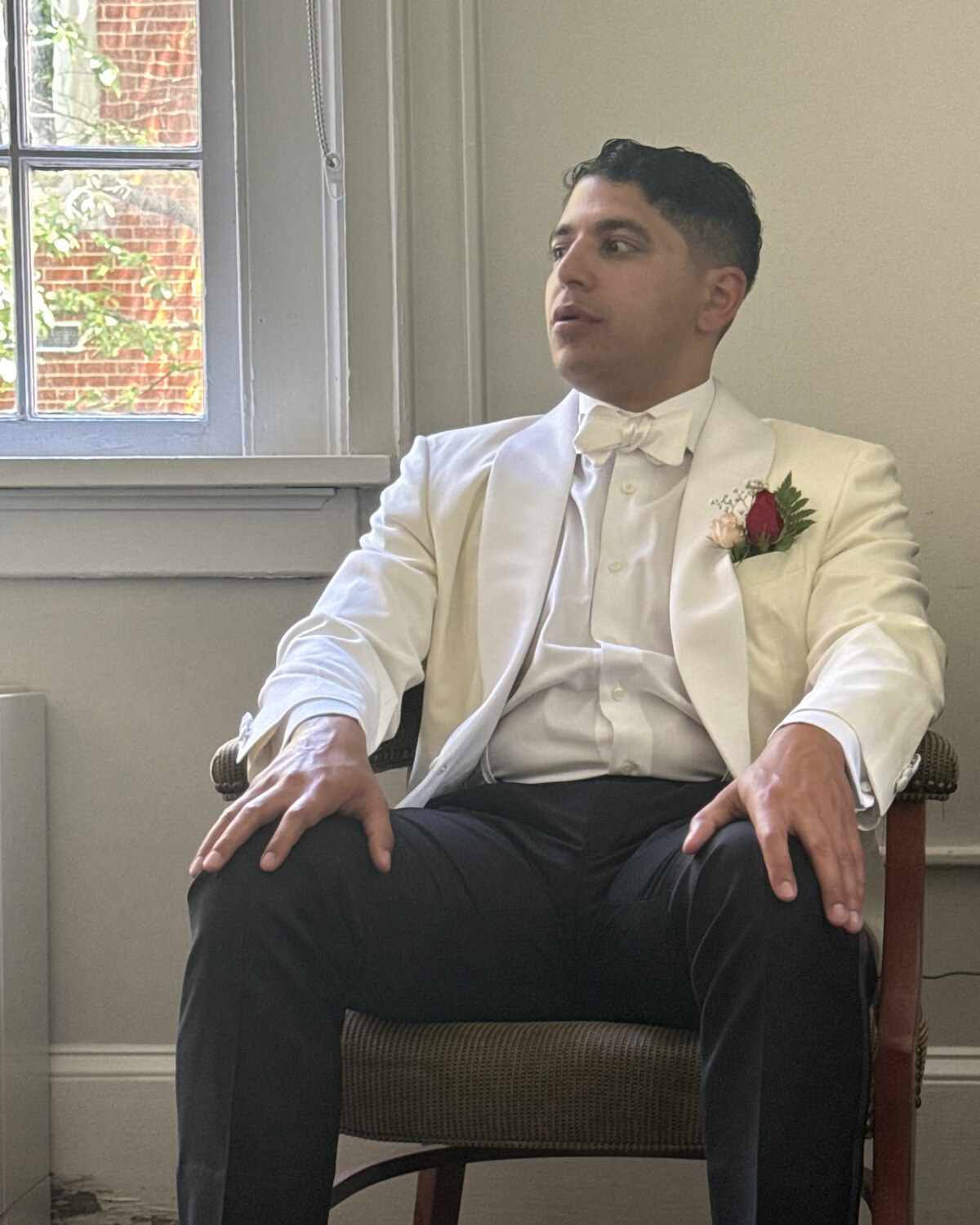Justus Eapen, seated, in a white dinner jacket